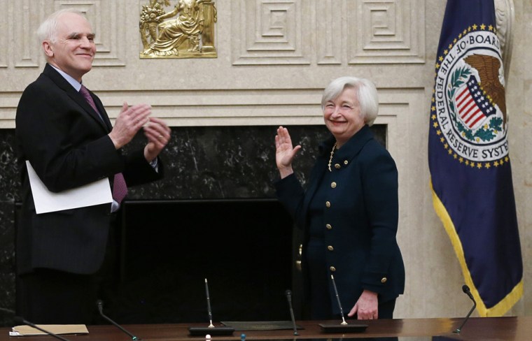 Federal Reserve Board Governor Daniel Tarullo (L) applauds new Federal Reserve Board Chairwoman Janet Yellen after administering the oath of office to...