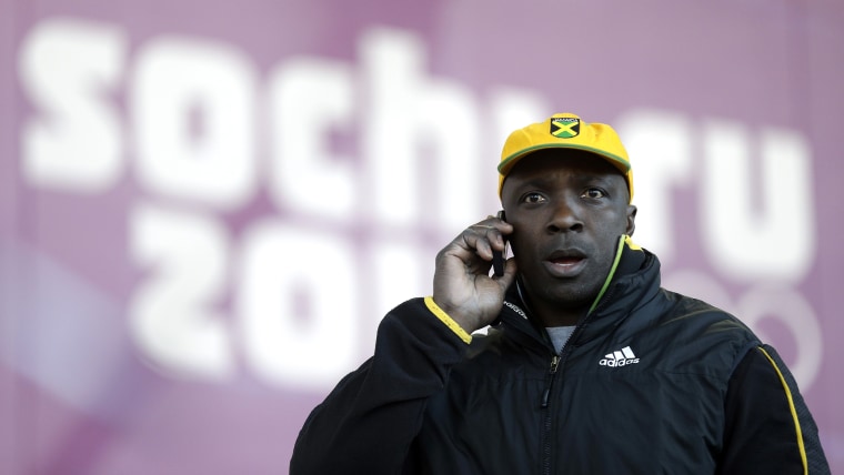 Winston Watts, the driver for JAM-1 of Jamaica, speaks on the phone after arriving at the sliding center during a training session for the men's two-man bobsled at the 2014 Winter Olympics, Wednesday, Feb. 5, 2014, in Krasnaya Polyana, Russia. Watts and his team were unable to practice because the Jamaican team equipment and luggage did not arrive in Sochi.