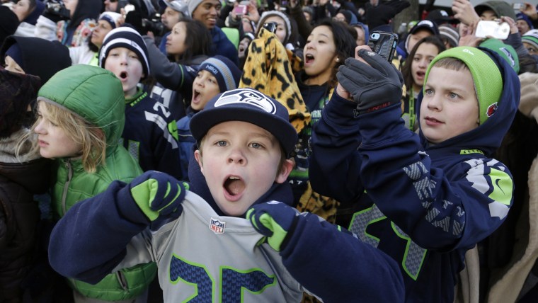 Young Seattle Seahawks fans cheer during the NFL team's Super Bowl victory parade in Seattle, Washington February 5, 2014. REUTERS/Jason Redmond (UNIT...