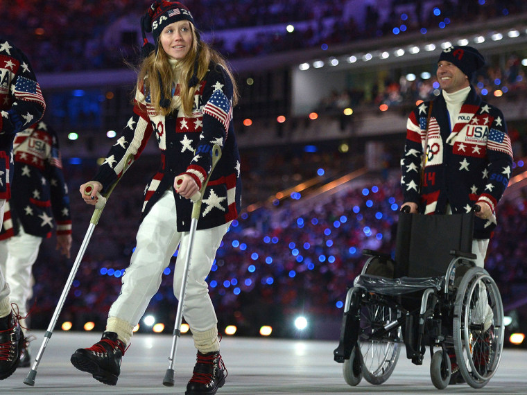 US skier Heidi Kloser walks with crutches as she parades with her delegation during the Opening Ceremony of the Sochi Winter Olympics at the Fisht Oly...