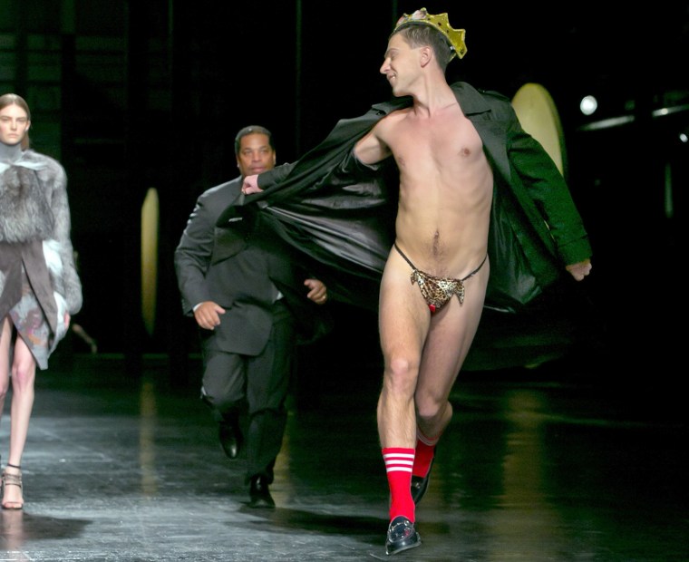 A streaker in a G-string, who interrupted the Prabal Gurung Fall 2014 collection as it is modeled, is chased by security, during Fashion Week, in New ...