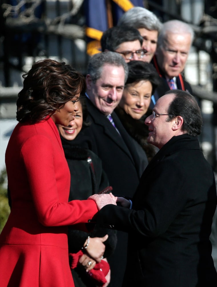 The French president greets Michelle Obama during a welcoming ceremony at the White House on Tuesday morning.
