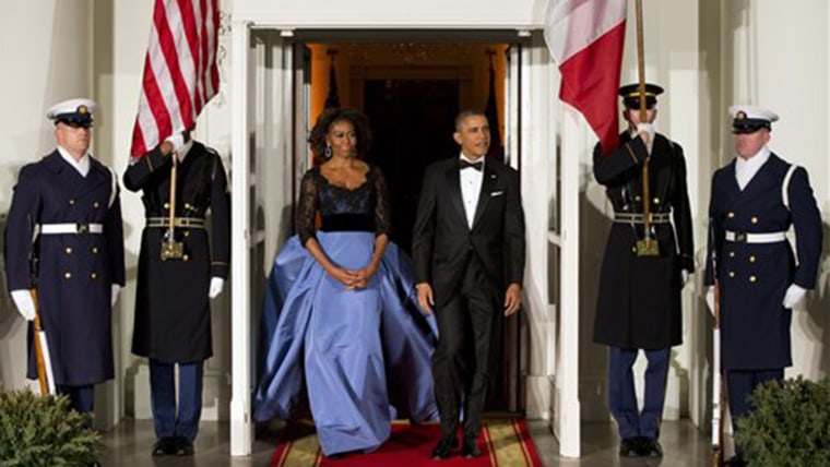 First lady Michelle Obama, left, and President Barack Obama wait for the arrival of French President FranÃ§ois Hollande for a State Dinner at the Nort...