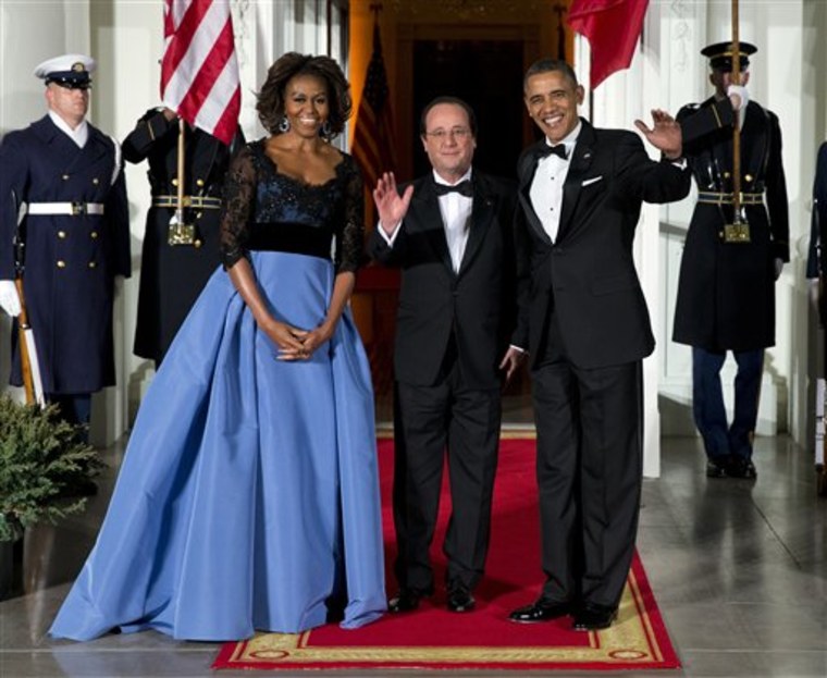 First lady Michelle Obama, left, and President Barack Obama welcome French President François Hollande