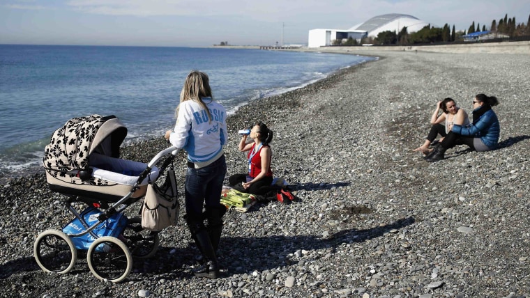 Local residents enjoy nice weather on the beach at the Black Sea near the Olympic Park during the 2014 Sochi Winter Olympics, February 12, 2014. REUTE...
