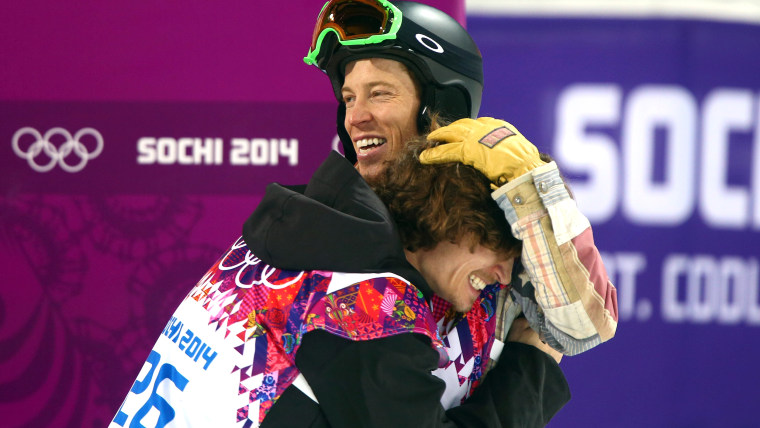 epa04070283 Gold medalist Iouri Podladtchikov of Switzerland (L) embraces Shaun White of USA (R) after the Men's Snowboard Halfpipe Final at Rosa Khut...