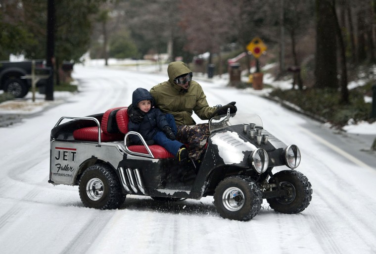 ATLANTA, GA - FEBRUARY 12: Bryan Fuller and his son, Cannon Fuller, tour a Druid Hills neighborhood in their customized golf cart on February 12, 2014...