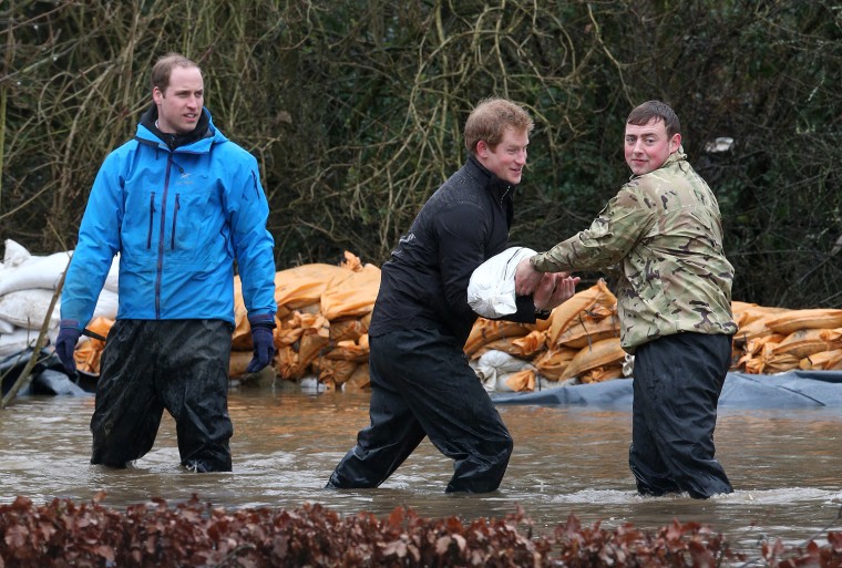 DATCHET, UNITED KINGDOM - FEBRUARY 14:  Prince William, Duke of Cambridge and Prince Harry help with flood defences around Eton End School on February...