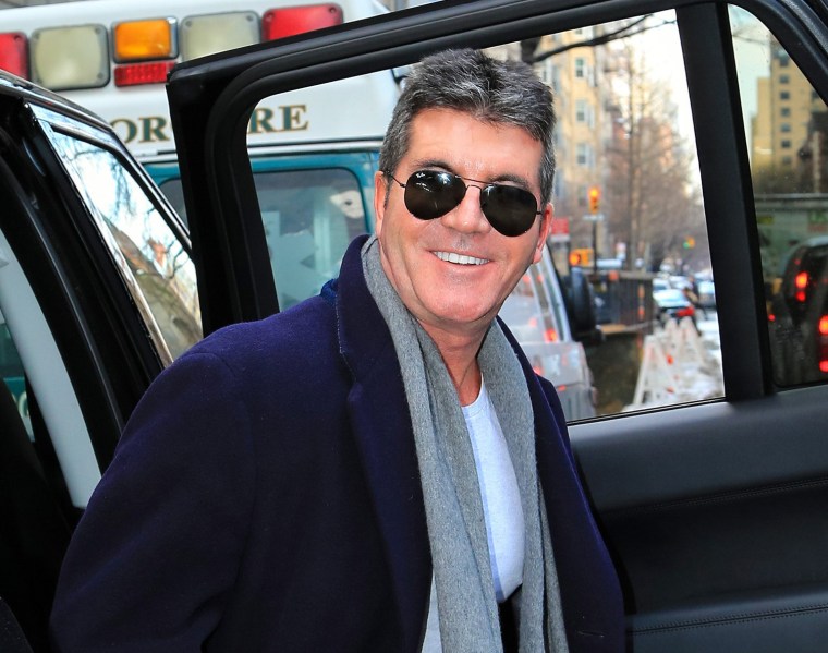 A very happy Simon Cowell is seen arriving at Lenox Hill Hospital on  New York City on Friday to wait for the birth of his son.