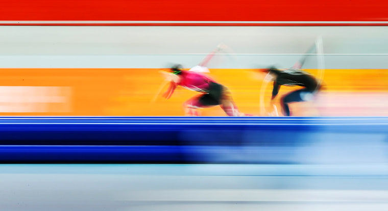 Two female speed skaters zip through the Adler Arena in Sochi