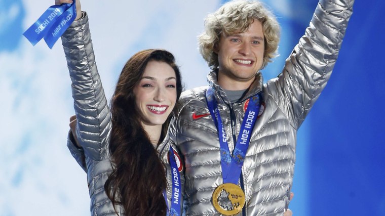 Gold medallists Meryl Davis and Charlie White of the U.S. celebrate during the medal ceremony for the figure skating ice dance free dance program at t...