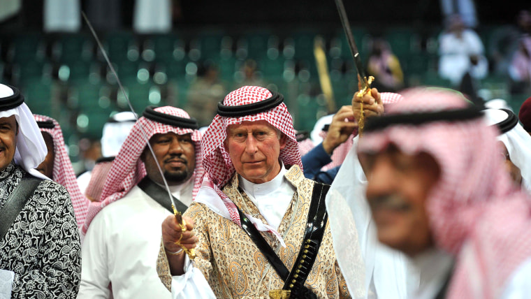 TOPSHOTS

Britain's Prince Charles (C) wearing traditional Saudi uniform, dances with sword during the traditional Saudi dancing best known as 'Arda' ...