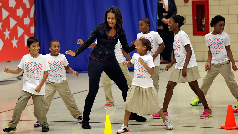WASHINGTON, DC - SEPTEMBER 06: U.S. first lady Michelle Obama exercises with schoolchildren at Orr Elementary School as part of a ''Let's Move! Active...