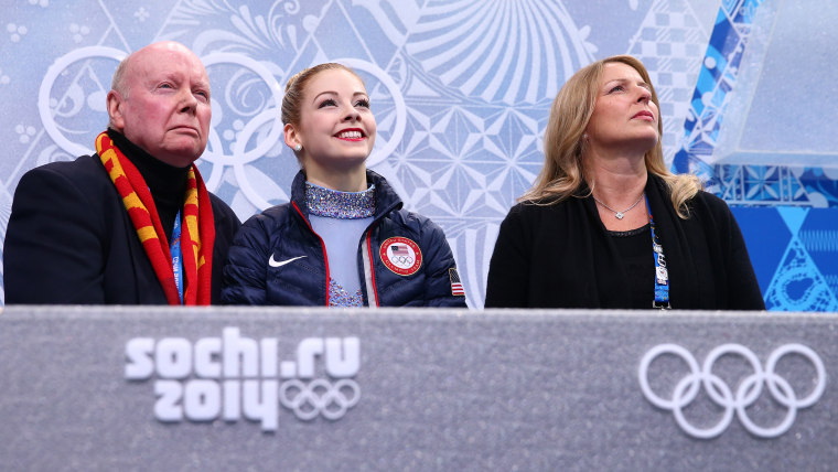 Gracie Gold (center) waits for her score with her coach Frank Carroll