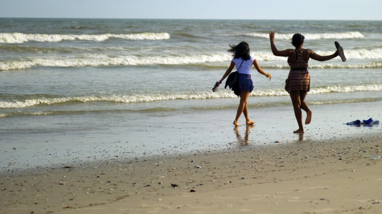 Tourists run on the beach near casinos in Atlantic City
