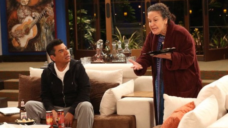 A scene from the first episode of \"Saint George\" starring 

George Lopez as George and Olga Merediz as Alma, his mother.