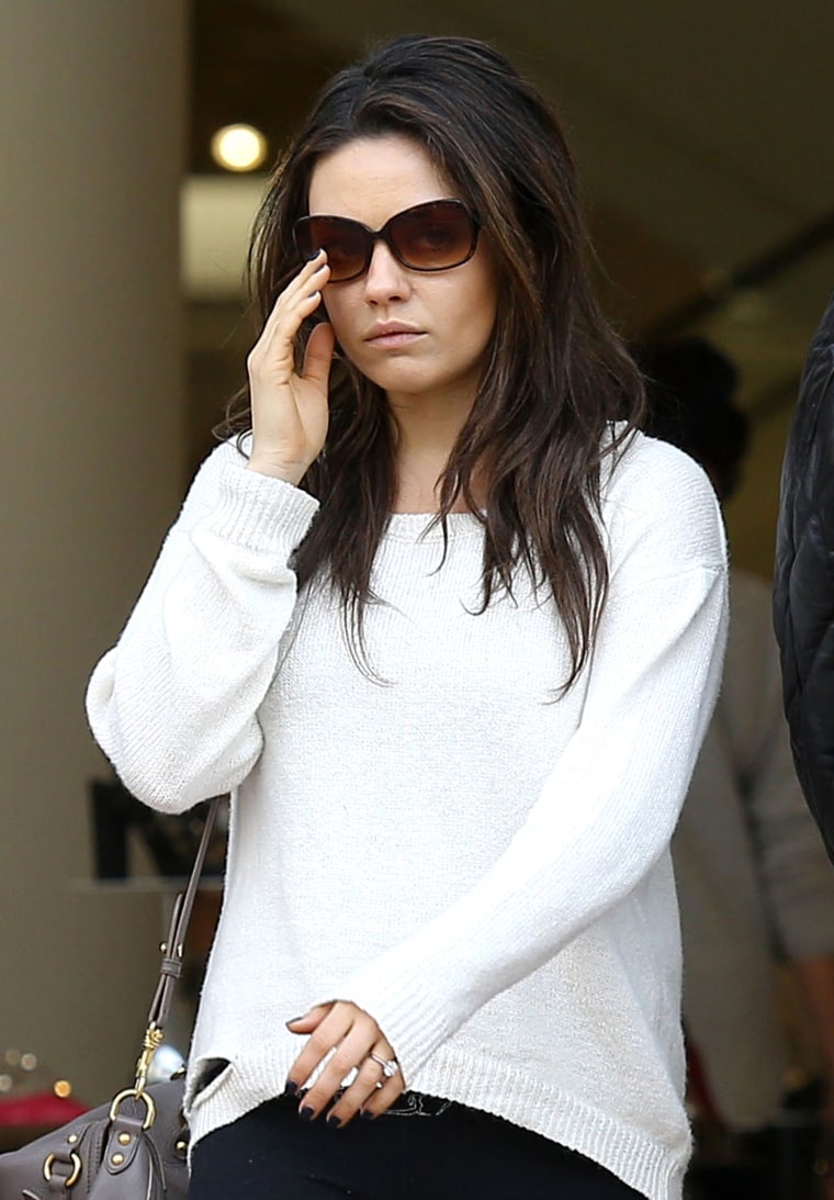 Mila Kunis takes her new ring out for a walk.