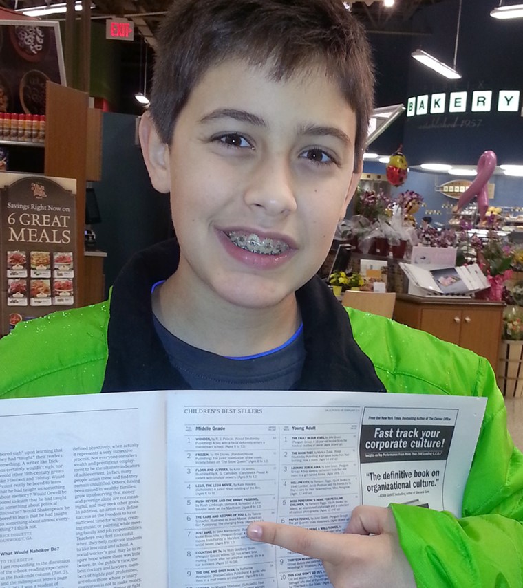 Jake points to his name and book on the New York times bestseller's list.