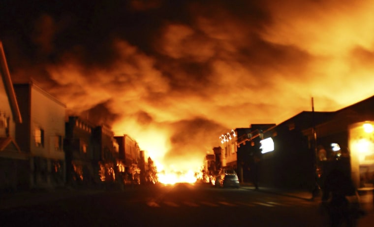Fire from a train explosion is seen in Lac-Megantic, in this file picture taken July 6, 2013. A fireball leveled the center of the picturesque lakeside town of Lac-Megantic, after a runaway freight train with 72 cars of crude oil derailed, killing about 50 people.