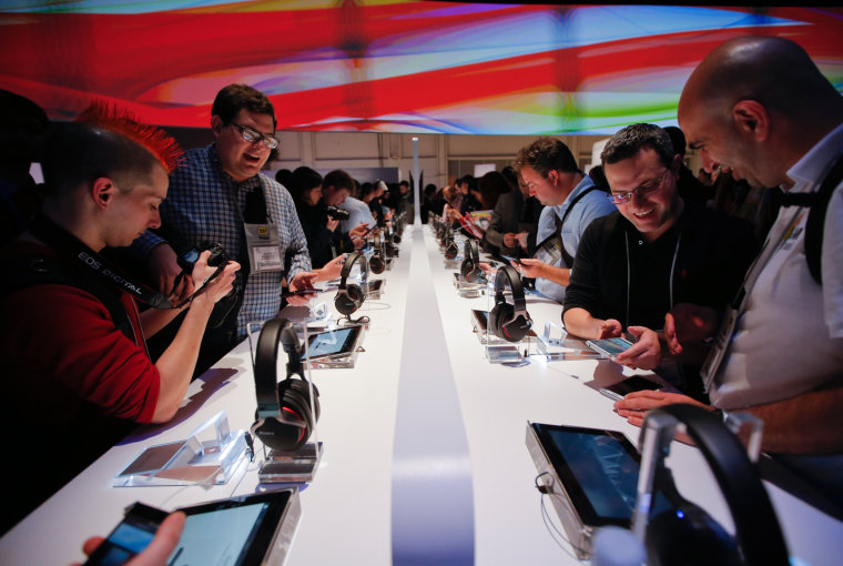 People check out Sony's new Xperia Z smartphones after a news conference at the International Consumer Electronics Show in Las Vegas, Monday, Jan. 7, ...