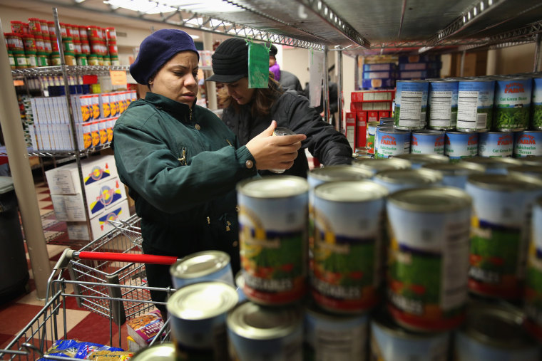 NEW YORK, NY - DECEMBER 11: Harlem residents choose free groceries at the Food Bank For New York City on December 11, 2013 in New York City. The food...