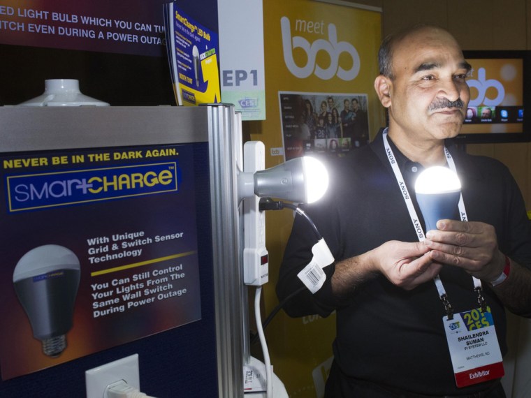 Founder Shailendra Suman poses with a SmartCharge LED lightbulb during \"CES Unveiled,\" a media preview event to the annual Consumer Electronics Show (...