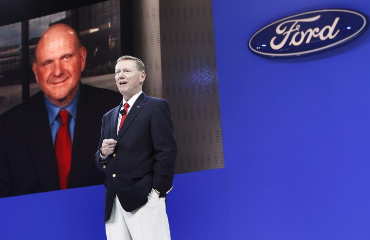 President and CEO of Ford Alan Mulally speaks as Microsoft CEO Steve Ballmer is seen on a video conference screen during the New York International Auto Show in this 2010, file photo. Mulally told The Associated Press on Jan. 7, 2014, that he won't leave Ford for Microsoft.