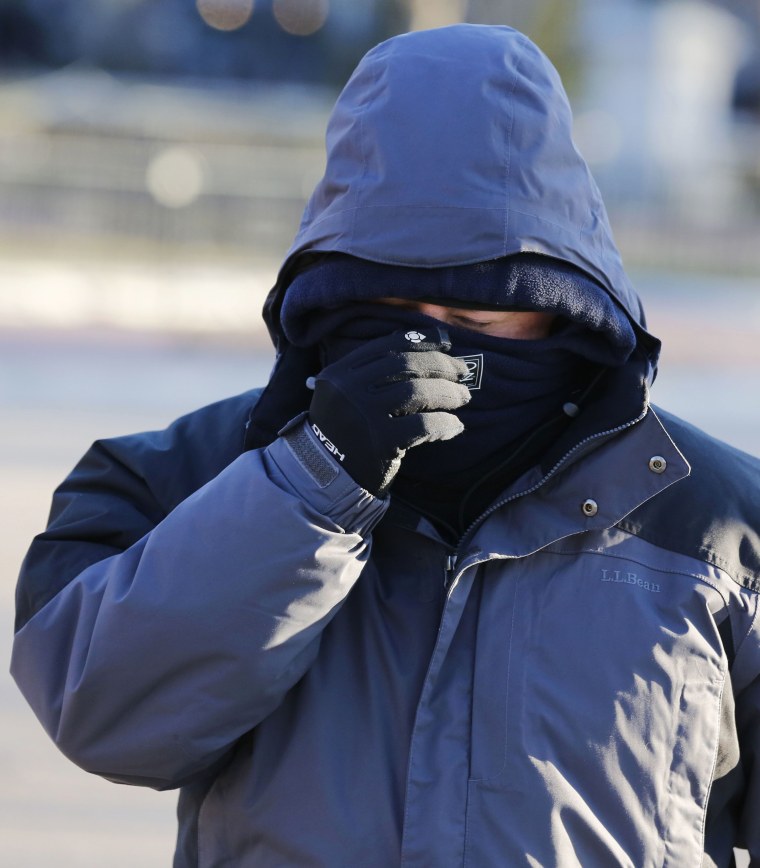 A man bundles up against the cold near the White House as temperatures plunged along the East coast due to the