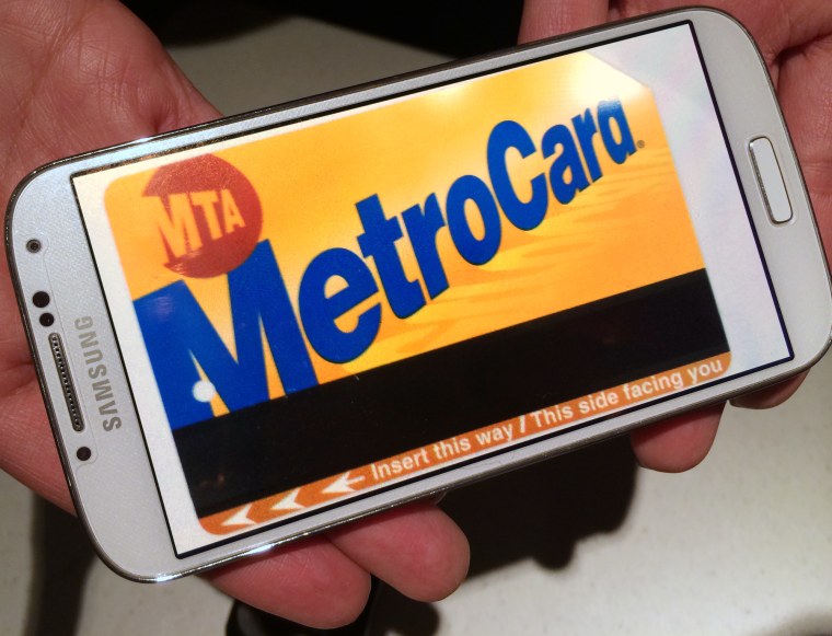 A MetroCard is displayed on a smartphone. The cards are expected be replaced in a few years with new technology that allows riders to use key chains, credit cards or their smartphones.