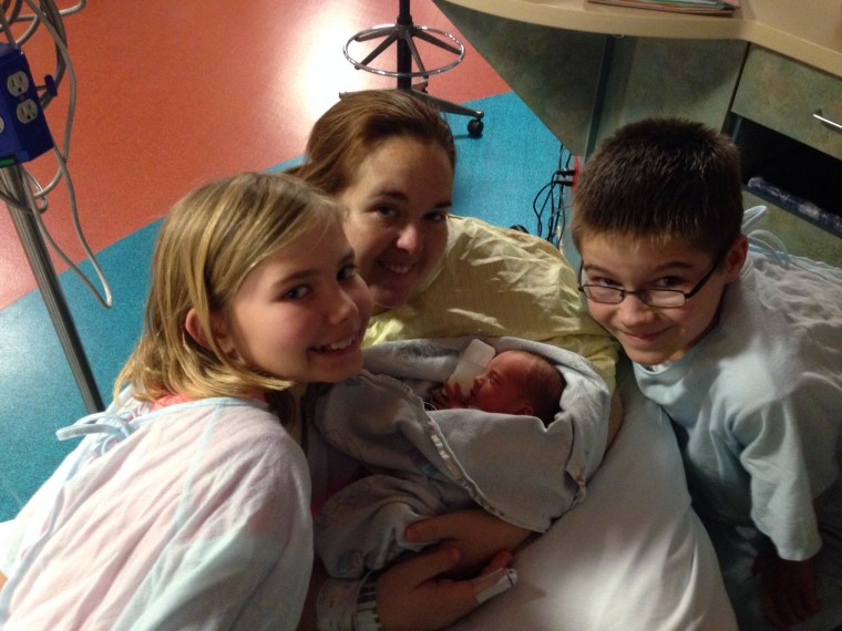 One big(ger) happy family: Caleb, 12, and Kaitlyn, 9, bond with their stepmom Amanda and one of their three new baby sisters.