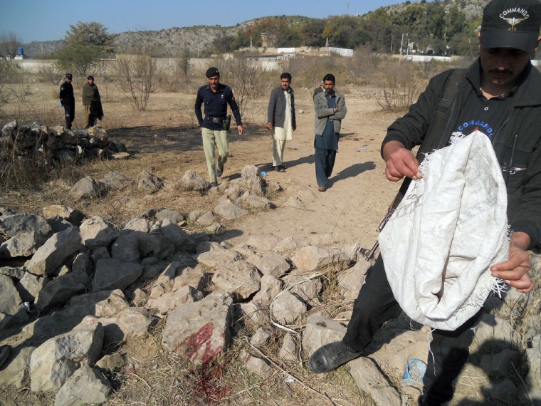 Pakistani security personnel examine the site of a suicide bombing in the Ibrahimzai area of Hangu district on Monday.