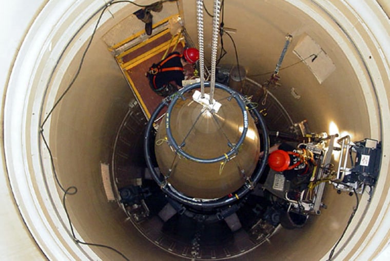 A Malmstrom Air Force Base missile maintenance team removes the upper section of an ICBM at a Montana missile site.