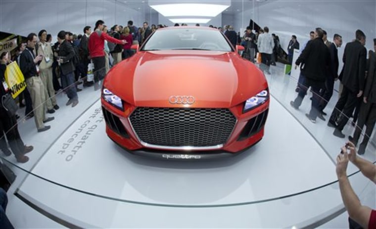 Trade show attendees gather around the Audi Sport quattro laserlight concept car at the International Consumer Electronics Show, Wednesday, Jan. 8, 2...