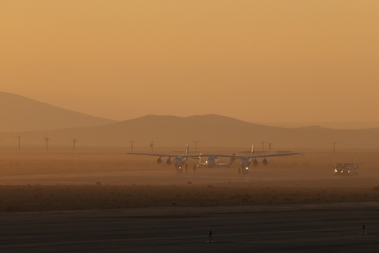 Virgin Galactic's White Knight 2 with SpaceshipTwo attached prepares to take off on a test flight.