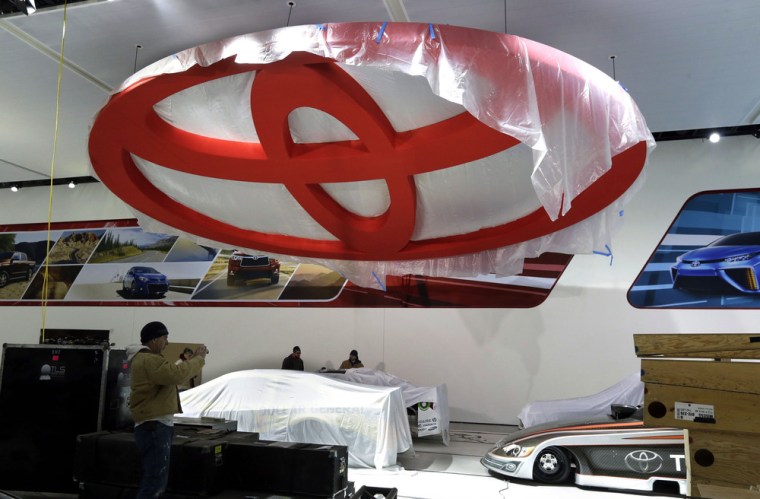The Toyota logo and race cars are under wraps inside Cobo Center, home of the North American International Auto Show in Detroit, seen here Jan. 9. Some 5,000 journalists and 800,000 spectators are expected to attend next week.