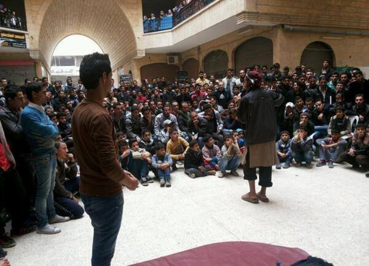 A member of the al-Qaida linked Islamic State of Iraq and the Levant (ISIL) gives a lecture at the Engineering College in the northern city of Raqqa, Syria, in this picture released in Nov. 2013, and posted on the Facebook page of a militant group.