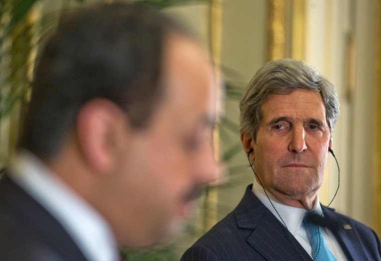 U.S. Secretary of State John Kerry, right, listens to Qatar's Foreign Minister Khalid al-Attiyah, left, during their joint news conference at the U.S. Ambassador's residence in Paris, France, on Sunday.