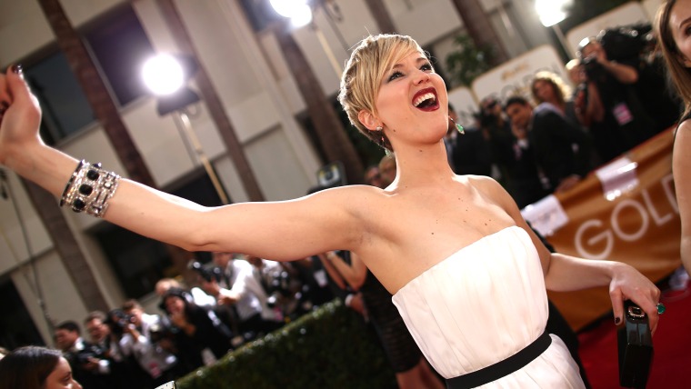 Jennifer Lawrence plays fast and loose with her bracelet arm on the red carpet at the Golden Globes.