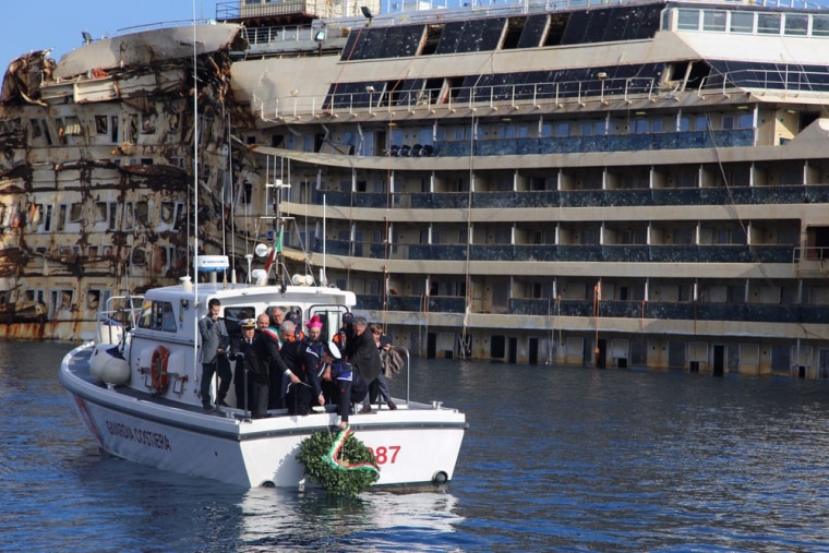 A wreath is lowered into the water near the shipwrecked Costa Concordia in honor of the 32 lives lost when the ship crashed two years ago, killing 32.