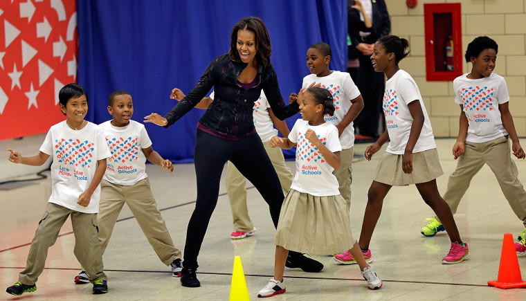 WASHINGTON, DC - SEPTEMBER 06: U.S. first lady Michelle Obama exercises with schoolchildren at Orr Elementary School as part of a ''Let's Move! Active...