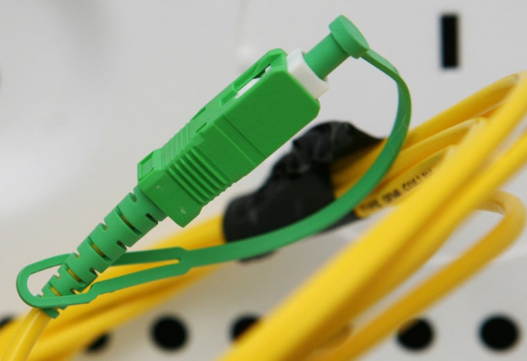 A green connector on a Verizon fiber optic cable is ready for an apartment renter to plug into for phone, cable and internet service at the 67 Wall St...
