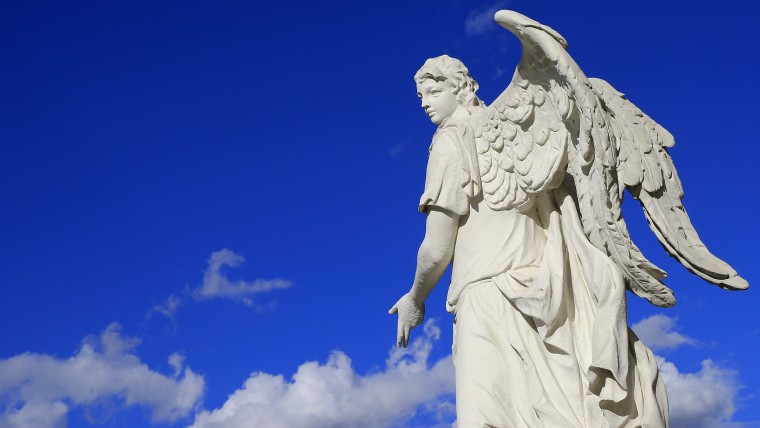 The statue of an angel is seen at the Karlskirche (St Charles's church) on a sunny day in Vienna as clouds are seen in the sky on April 13, 2013. The ...