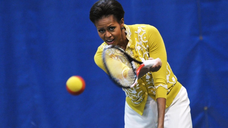US First Lady Michelle Obama plays tennis while attending a mini-Olympics event with local school children at American University's Bender Arena March...