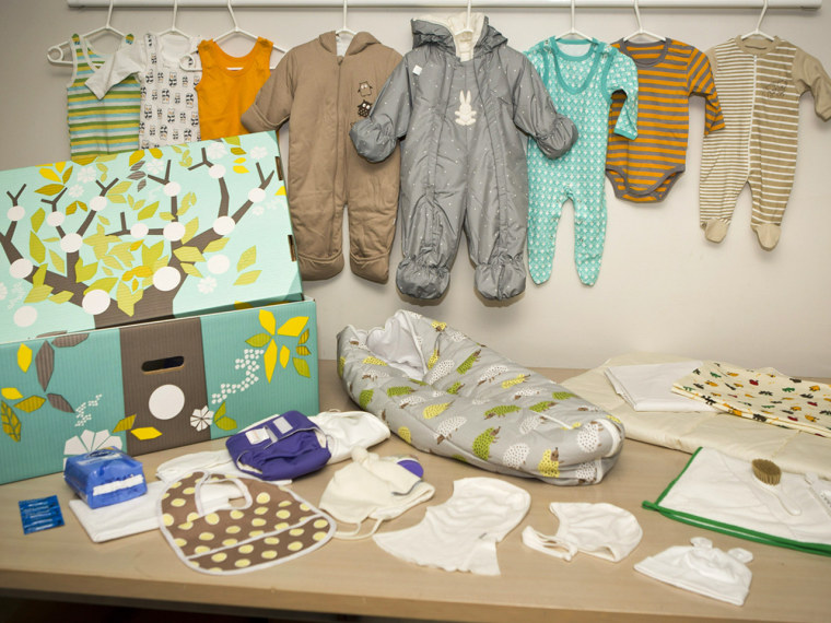 The contents of the maternity gift box Finland's social security service sent to Prince William and Duchess Kate for their baby, Prince George. The brightly colored cardboard box doubles as a cot, complete with mattress and sheets.
