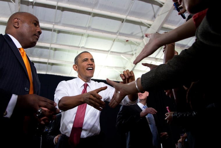 President Barack Obama shakes hands with audience members as he arrives to speak about the economy, jobs and manufacturing, Wednesday, Jan. 15, 2014, ...