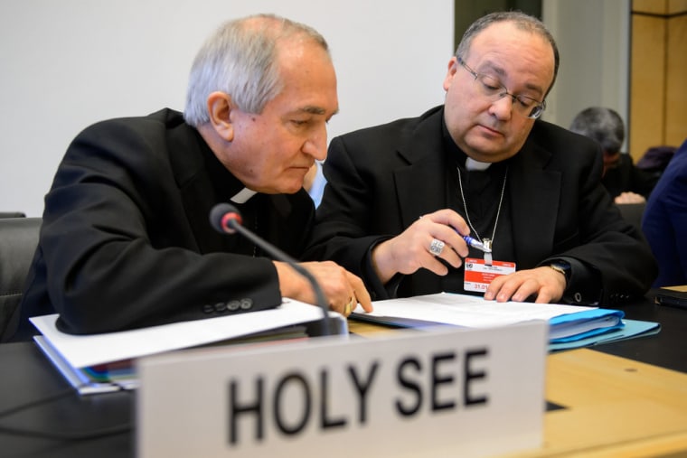 The Vatican's U.N. Ambassador Monsignor Silvano Tomasi (L) speaks with Charles Scicluna, its former chief prosecutor of clerical sexual abuse, before the start of questioning on Thursday.