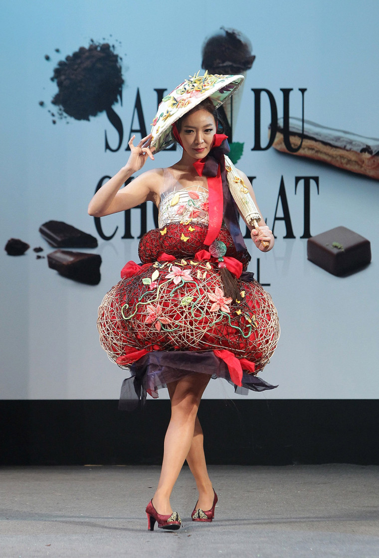 A model shows off her dress and accessories adorned with chocolate.