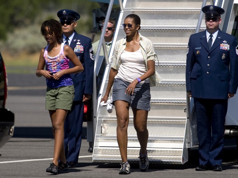 First lady Michelle Obama and daughter Malia Obama, walk off Air Force One at Grand Canyon National Park Airport in Tusayan, Ariz.,  Sunday, Aug. 16, ...