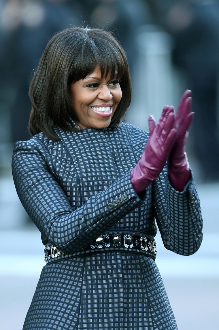 First lady Michelle Obama walks the route as the presidential inaugural parade winds through the nation's capital in Washington, DC., USA,...