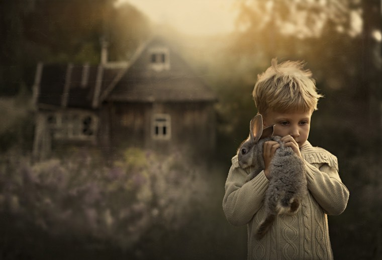 Five-year-old Yaroslav Shumilova holds one of his family's rabbits.